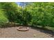Outdoor fire pit surrounded by lush trees, perfect for relaxing evenings at 1758 Rosehedge Nw Way, Kennesaw, GA 30152