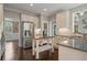 Bright, spacious kitchen features granite countertops, stainless steel appliances, and wooden floors at 1758 Rosehedge Nw Way, Kennesaw, GA 30152