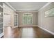 Living room with hardwood floors, French doors, beautiful arched windows, and neutral wall colors at 1758 Rosehedge Nw Way, Kennesaw, GA 30152
