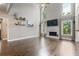 Bright living room with tall ceilings, fireplace, hardwood floors, and large windows at 1758 Rosehedge Nw Way, Kennesaw, GA 30152
