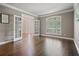 Living room with hardwood floors, French doors, beautiful arched windows, and neutral wall colors at 1758 Rosehedge Nw Way, Kennesaw, GA 30152