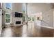 Bright living room with tall ceilings, fireplace, hardwood floors, and large windows at 1758 Rosehedge Nw Way, Kennesaw, GA 30152