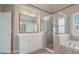 Attractive main bathroom offers a glass shower, soaking tub, and vanity with seating at 1758 Rosehedge Nw Way, Kennesaw, GA 30152