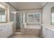 Bright main bathroom features a large soaking tub, glass enclosed shower and double vanity at 1758 Rosehedge Nw Way, Kennesaw, GA 30152