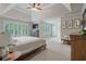 Generous main bedroom has a ceiling fan, plenty of natural light, and neutral carpeting at 1758 Rosehedge Nw Way, Kennesaw, GA 30152