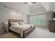 Spacious main bedroom features trey ceiling, ceiling fan, large window and neutral carpeting at 1758 Rosehedge Nw Way, Kennesaw, GA 30152