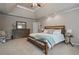 Large main bedroom boasts tray ceiling, ceiling fan, plush carpet and large window at 1758 Rosehedge Nw Way, Kennesaw, GA 30152