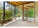Screened in porch with a ceiling and sliding door leading to greenery at 1758 Rosehedge Nw Way, Kennesaw, GA 30152