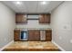Wet bar with travertine tile floors, undercounter fridge, cabinets, and a granite countertop at 1758 Rosehedge Nw Way, Kennesaw, GA 30152
