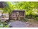 Cozy screened-in back porch with wood trim surrounded by mature trees and professional landscaping at 230 King Arthur Dr, Woodstock, GA 30189