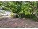 Backyard featuring a charming patio area surrounded by lush greenery and a wooden fence at 230 King Arthur Dr, Woodstock, GA 30189