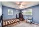This bedroom includes two windows, a ceiling fan and ample space for furniture at 230 King Arthur Dr, Woodstock, GA 30189