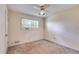 A bright bedroom with neutral walls features a large window and wall-mounted air conditioner at 230 King Arthur Dr, Woodstock, GA 30189