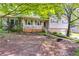 Charming home featuring a quaint front porch with green shutters, creating a welcoming facade at 230 King Arthur Dr, Woodstock, GA 30189