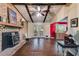 Bright living room has beamed ceilings, hardwood floors, and french doors leading to the backyard at 230 King Arthur Dr, Woodstock, GA 30189
