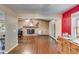 Bright open floorplan living room featuring a brick fireplace and hardwood floors at 230 King Arthur Dr, Woodstock, GA 30189