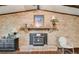 Cozy living room features a brick fireplace with a wooden mantle and a decorative wood-burning stove at 230 King Arthur Dr, Woodstock, GA 30189