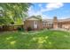 This home has a backyard with a lawn and lovely brick home with stone patio at 2785 Fontainebleau Dr, Dunwoody, GA 30360