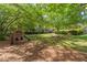 Backyard of this home offers a peaceful retreat with a play area under mature trees at 2785 Fontainebleau Dr, Dunwoody, GA 30360
