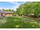 The backyard has a lush green lawn, mature trees and a stone patio for outdoor enjoyment at 2785 Fontainebleau Dr, Dunwoody, GA 30360