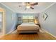 Calming bedroom features wood floors, ceiling fan, and lots of natural light at 2785 Fontainebleau Dr, Dunwoody, GA 30360