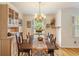 Traditional dining room with hardwood floors, ample natural light, and decorative chandelier at 2785 Fontainebleau Dr, Dunwoody, GA 30360