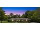 Brick home illuminated at twilight showing blue shutters and manicured landscaping at 2785 Fontainebleau Dr, Dunwoody, GA 30360