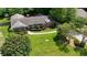 Aerial front view of a well-maintained brick home with a green lawn and landscaped yard at 2785 Fontainebleau Dr, Dunwoody, GA 30360