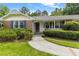 Inviting home entrance featuring a brick walkway, established bushes and shuttered windows at 2785 Fontainebleau Dr, Dunwoody, GA 30360