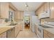 Bright galley kitchen with stainless steel appliances, tile floor, and wood cabinets at 2785 Fontainebleau Dr, Dunwoody, GA 30360