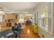 Bright living room featuring hardwood floors and direct sightlines to dining area and outdoor porch at 2785 Fontainebleau Dr, Dunwoody, GA 30360