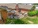 Aerial view of a brick home with a beautiful stone patio featuring an outdoor dining area at 2785 Fontainebleau Dr, Dunwoody, GA 30360