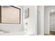 Clean bathroom featuring tub, glass door shower, picture window, and access to walk-in closet at 6571 Splitpine Ct, Atlanta, GA 30349