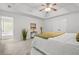 Spacious bedroom featuring neutral walls, plush carpet, tray ceilings, and ensuite bathroom at 6571 Splitpine Ct, Atlanta, GA 30349