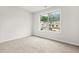 Bright bedroom with large window offering neighborhood views and neutral carpeting at 6571 Splitpine Ct, Atlanta, GA 30349