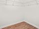 Walk-in closet includes white wire shelving and wood flooring at 6571 Splitpine Ct, Atlanta, GA 30349