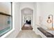 Hallway with arched doorways, stone floors and a modern table lamp, leading to the living spaces at 6571 Splitpine Ct, Atlanta, GA 30349