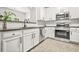 Modern kitchen features stainless steel appliances, granite countertops, and white cabinetry at 6571 Splitpine Ct, Atlanta, GA 30349