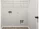 Utility room featuring gray tile flooring and utility connections at 6571 Splitpine Ct, Atlanta, GA 30349