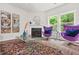 Cozy living room with fireplace, plush armchairs, and large windows offering scenic views at 6571 Splitpine Ct, Atlanta, GA 30349