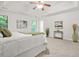 Bright main bedroom featuring a tray ceiling, carpet and a scenic view from the windows at 6571 Splitpine Ct, Atlanta, GA 30349