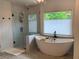 Contemporary bathroom featuring a freestanding tub and a separate glass-enclosed shower at 970 Tarpley Nw Rd, Kennesaw, GA 30152
