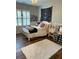 Cozy bedroom with a white bed, shuttered windows, and decorative wall hangings at 970 Tarpley Nw Rd, Kennesaw, GA 30152