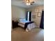 Comfortable bedroom featuring a neatly made bed, side table and warm, neutral decor at 970 Tarpley Nw Rd, Kennesaw, GA 30152