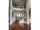 Elegant foyer with hardwood floors, a staircase, and a view to the living room at 970 Tarpley Nw Rd, Kennesaw, GA 30152