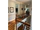 Upstairs hallway with hardwood floors, decorative railing, and views of bedrooms and playroom at 970 Tarpley Nw Rd, Kennesaw, GA 30152