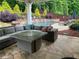 Outdoor patio with ample seating surrounding a gas fire pit, overlooking a pool and lush landscaping at 970 Tarpley Nw Rd, Kennesaw, GA 30152