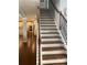 Elegant staircase with wooden steps, white risers, and a decorative wrought iron railing at 970 Tarpley Nw Rd, Kennesaw, GA 30152
