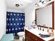 Charming bathroom with vanity, white sink and a blue patterned shower curtain at 1150 Rankin St # 19O, Stone Mountain, GA 30083