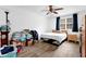 Cozy bedroom with hardwood floors, ceiling fan, a window and a comfortable bed at 1150 Rankin St # 19O, Stone Mountain, GA 30083